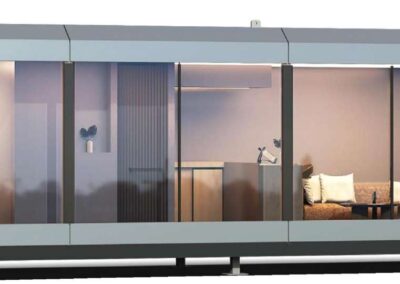 BAUSTADT F70 prefab house illuminated at night exterior view
