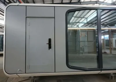 BAUSTADT Space Capsule House A50 modern modular prefab tiny home exterior front view with panoramic glass window