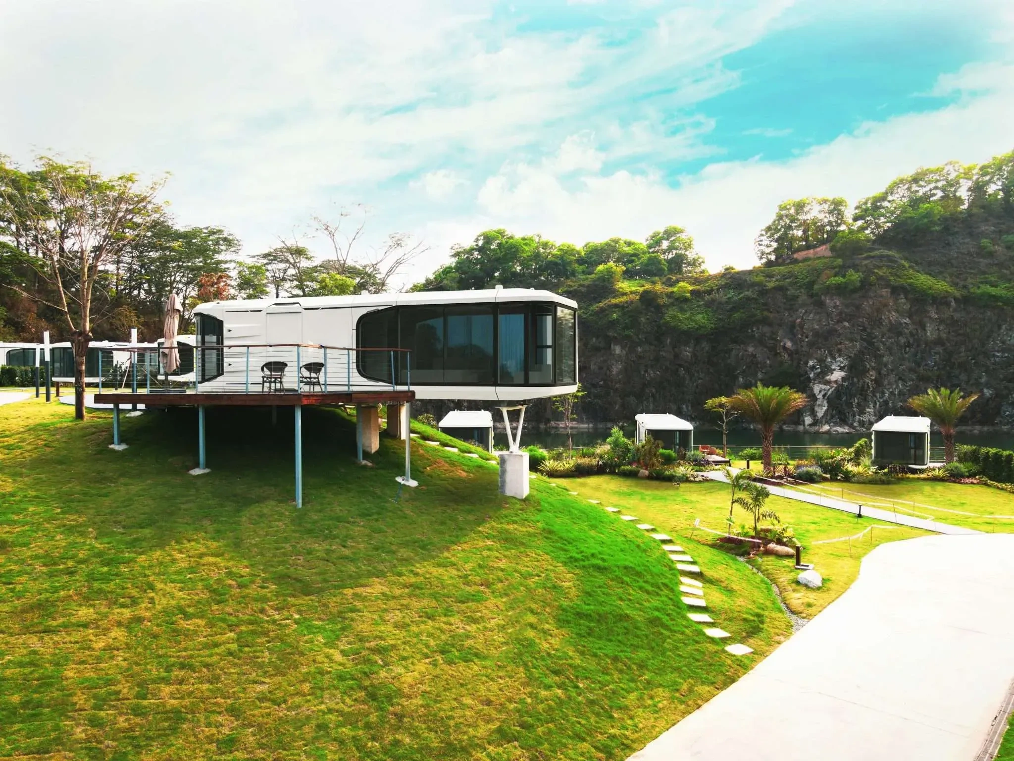 BAUSTADT capsule home with terrace in green landscape