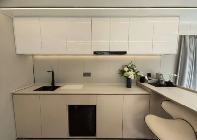 Compact kitchen inside BAUSTADT G50 prefab capsule house with built-in cabinets