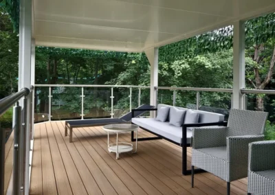 BAUSTADT Capsule House D8 rooftop terrace seating area with glass railing